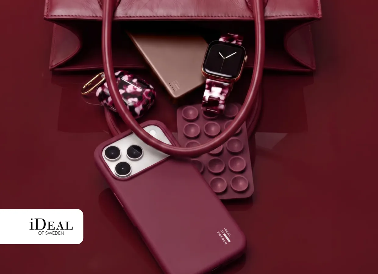 iDeal of Sweden burgundy iPhone case, Apple Watch strap and AirPods case with a handbag
